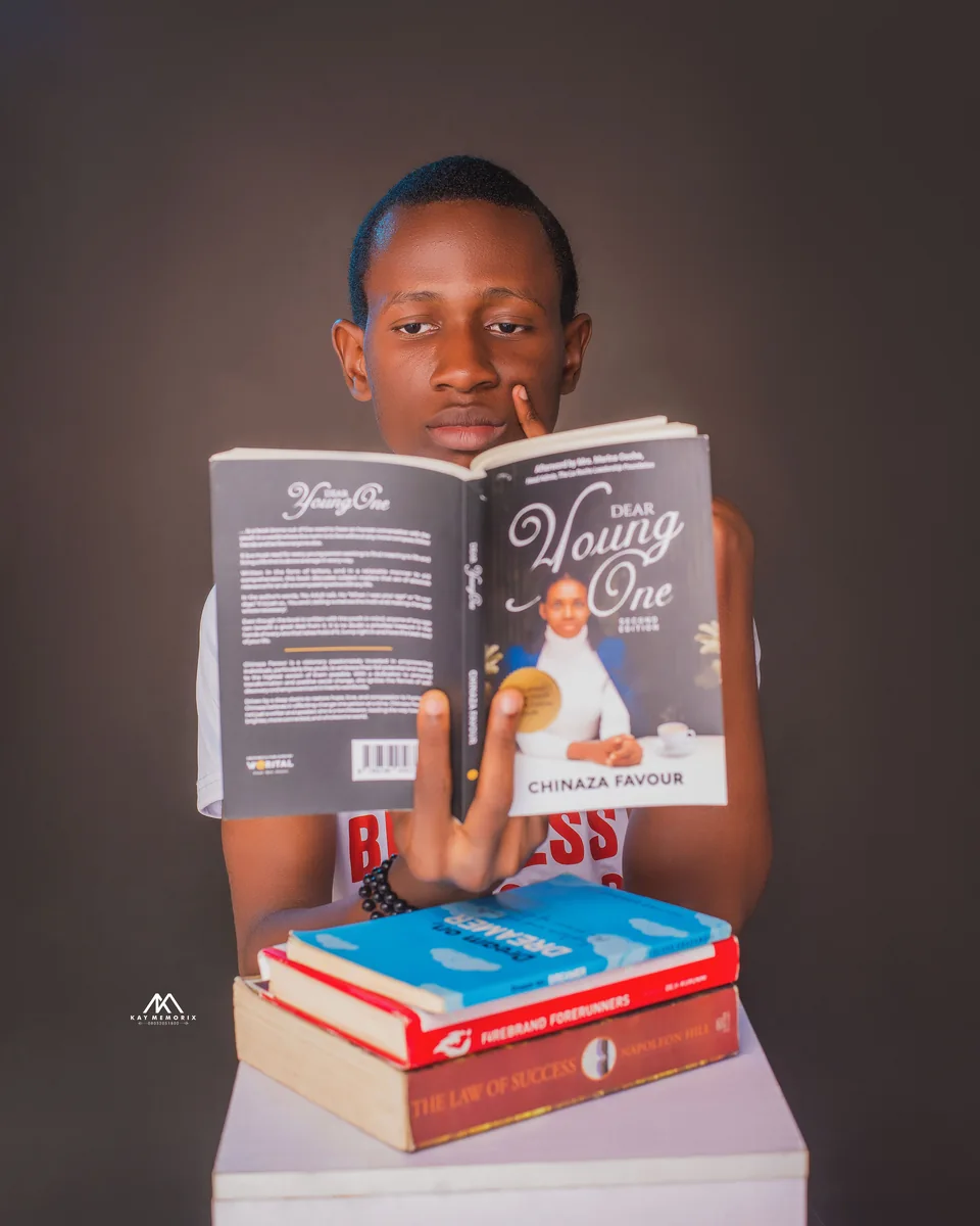 Divine reading Dear Young One by Chinaza Favour. Photograph by Kay Memorix.